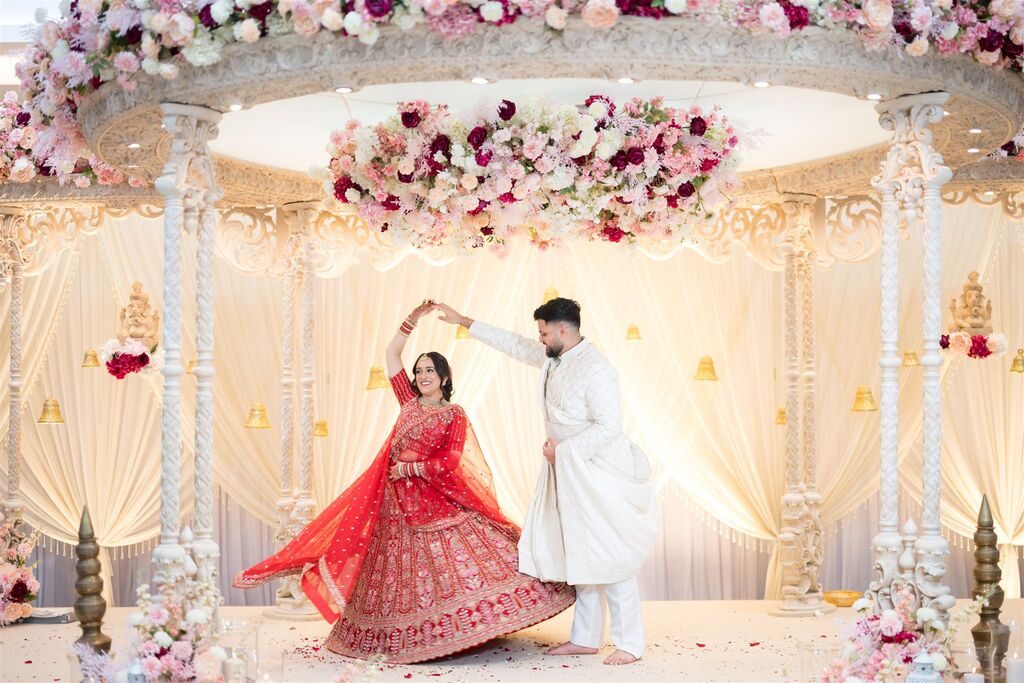 Couple dancing in front of the mandap at the Grand Connaught Rooms